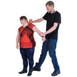 Two individuals standing, one grabbing the other's shirt.