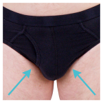 Close-up of a person wearing black briefs with two blue arrows pointing towards the central area.